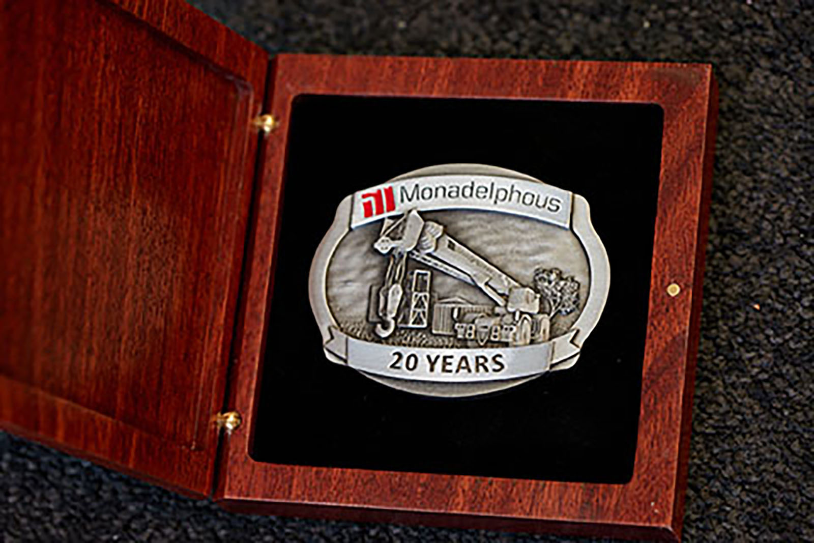 Custom pewter belt buckle produced for Monadelphous service recognition, presented in a jarrah box