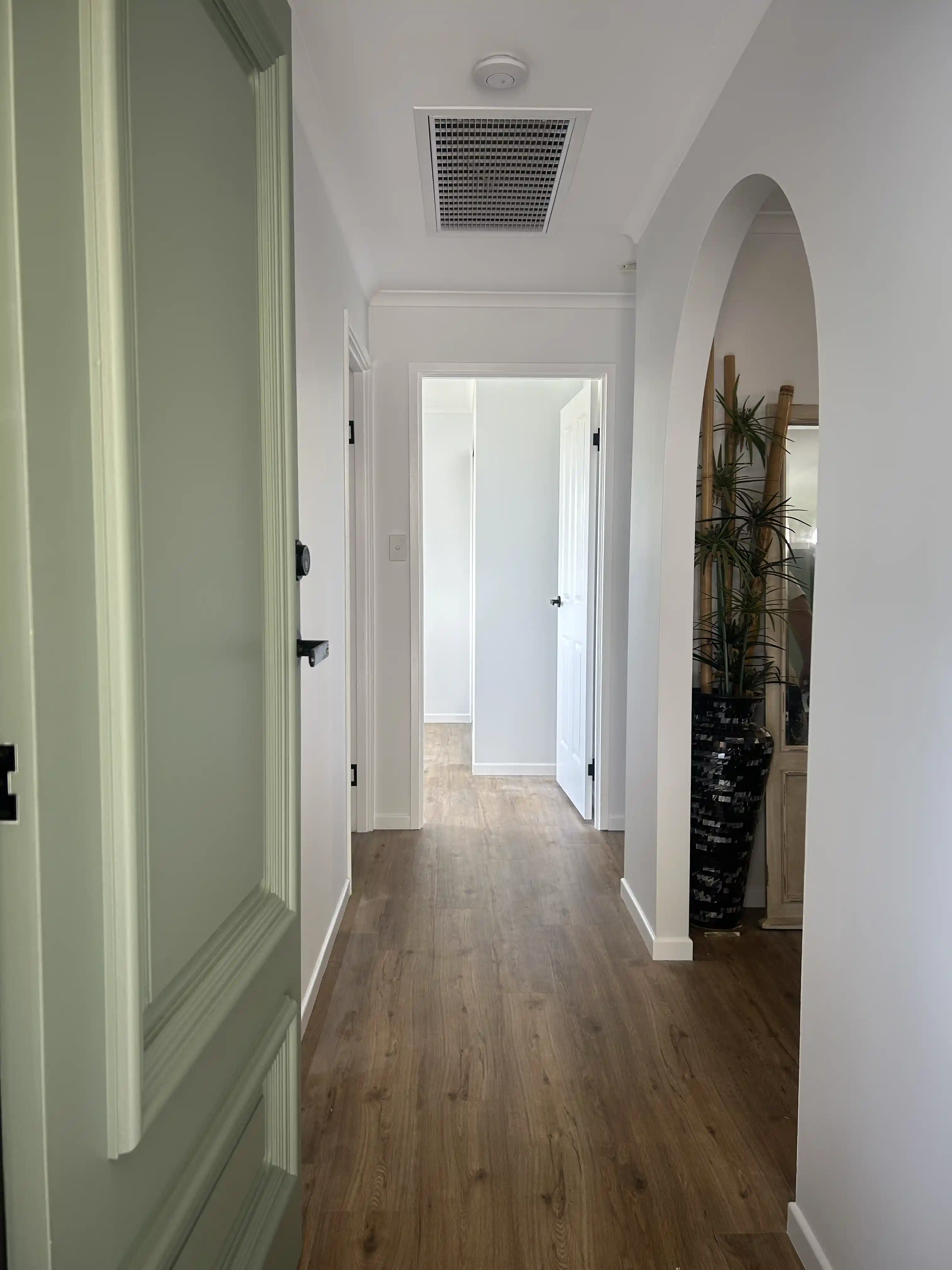 Freshly painted doorway and hallway with the front door of the home open