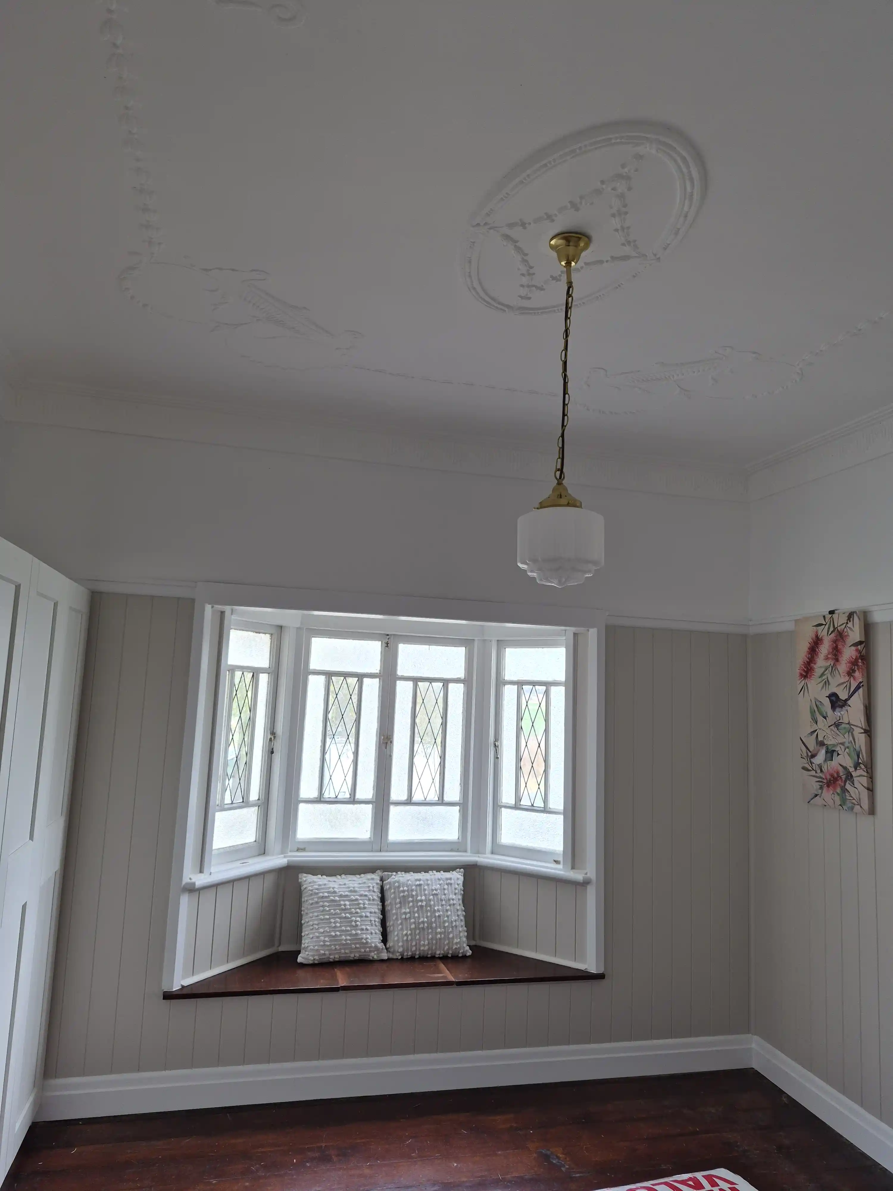 Freshly painted bedroom with a casement window in a Colonial style home