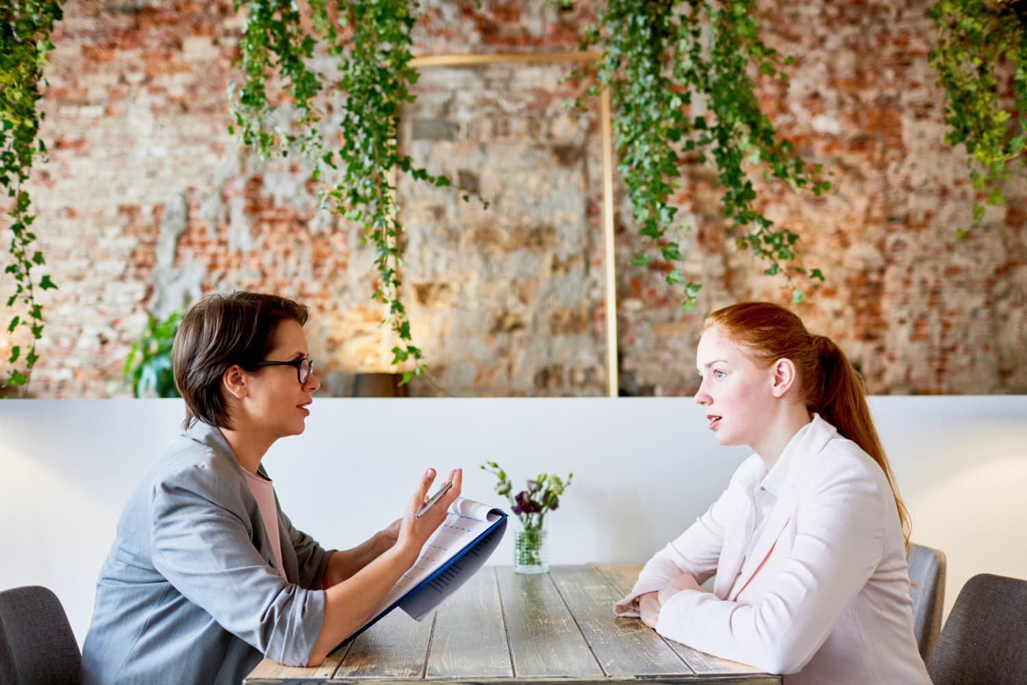 Two women sitting down having a meaningful conversation