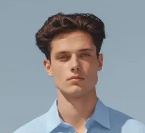 Young man with dark hair wearing a light blue shirt against a clear sky background.