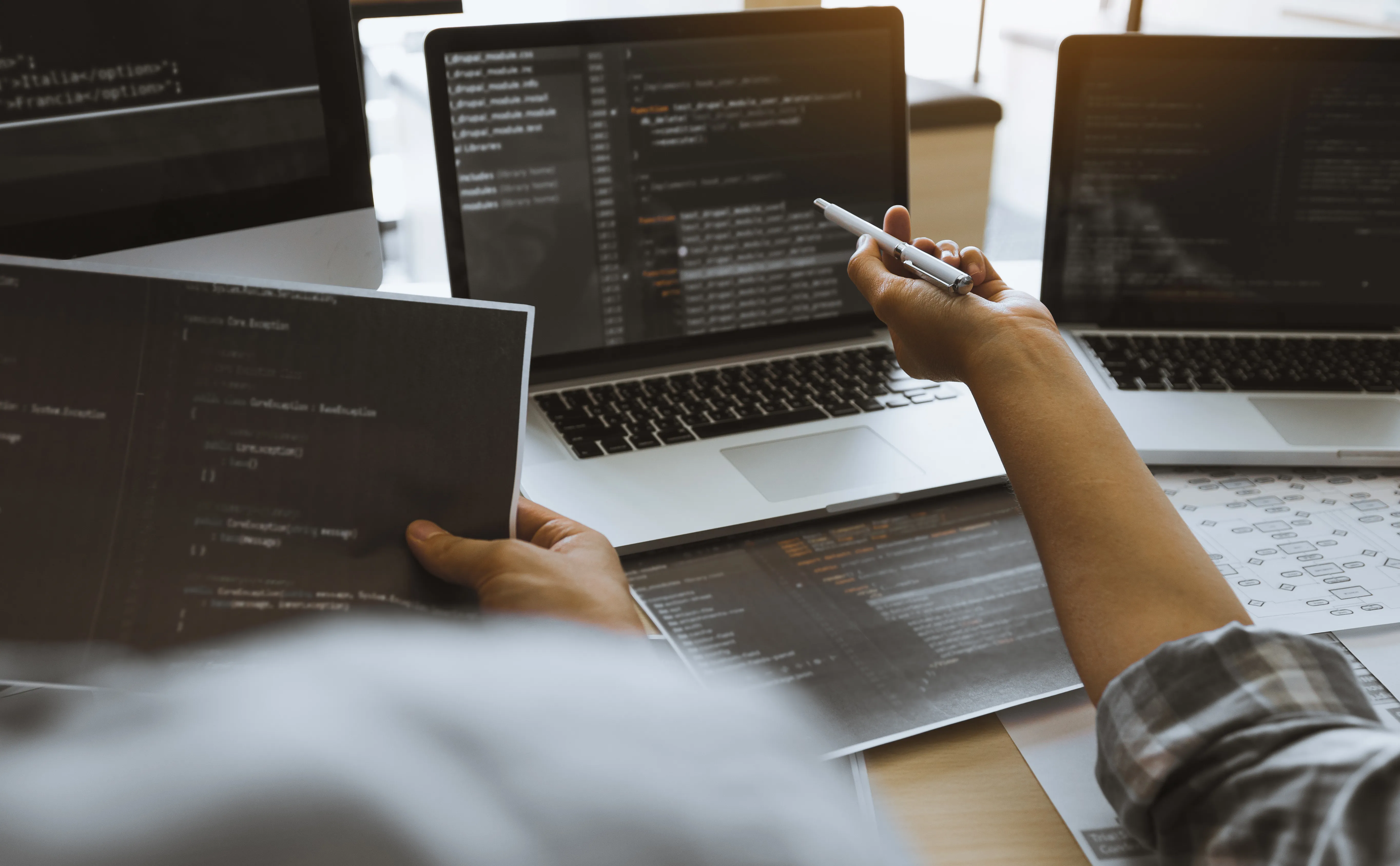 Pointing towards the coding dark screen.