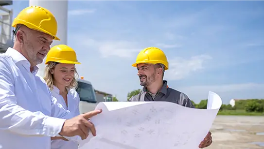 Workers discussing the maps on the site