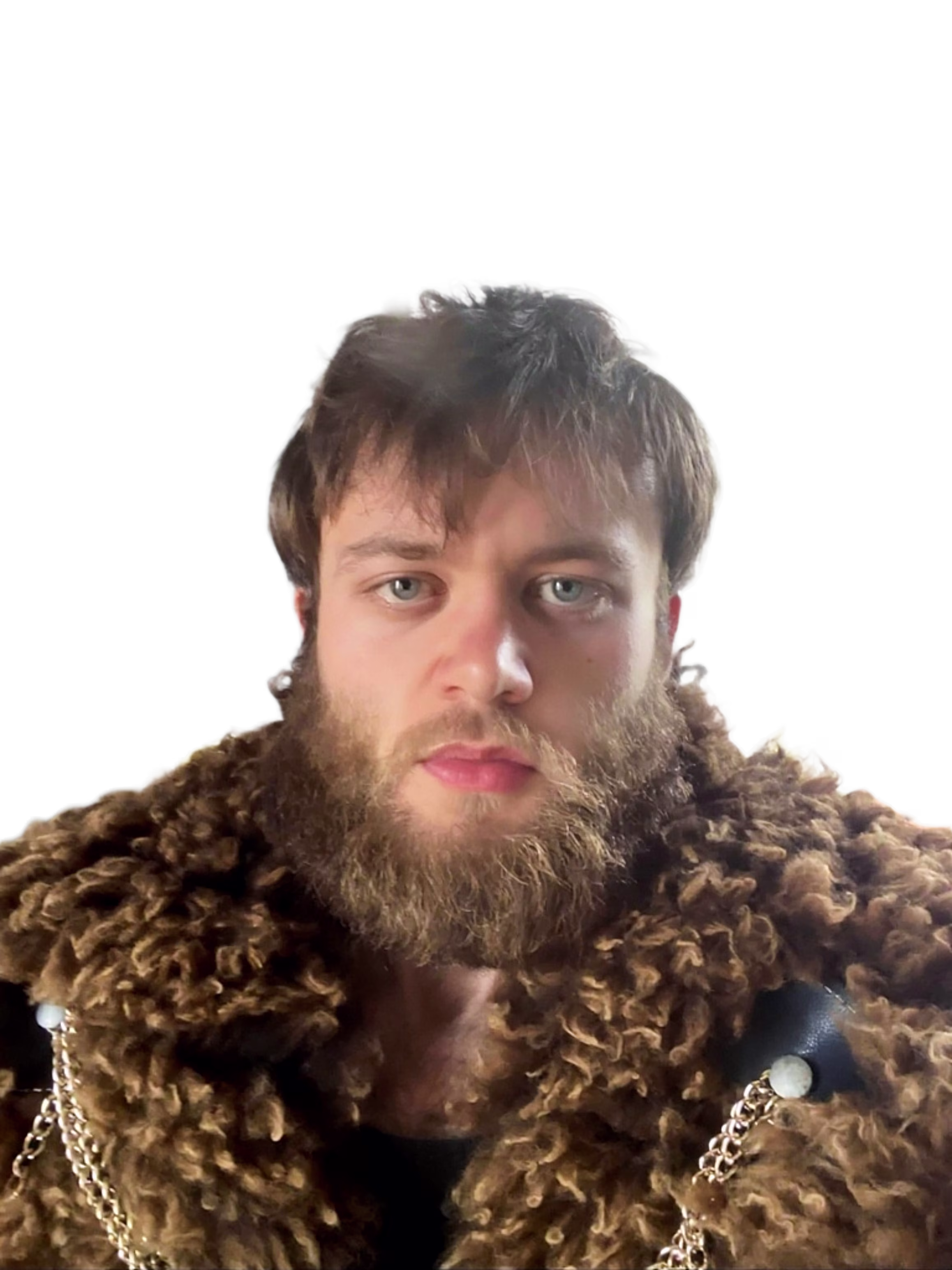 A headshot of Oliver Lucas Taylor wearing a wool cape.