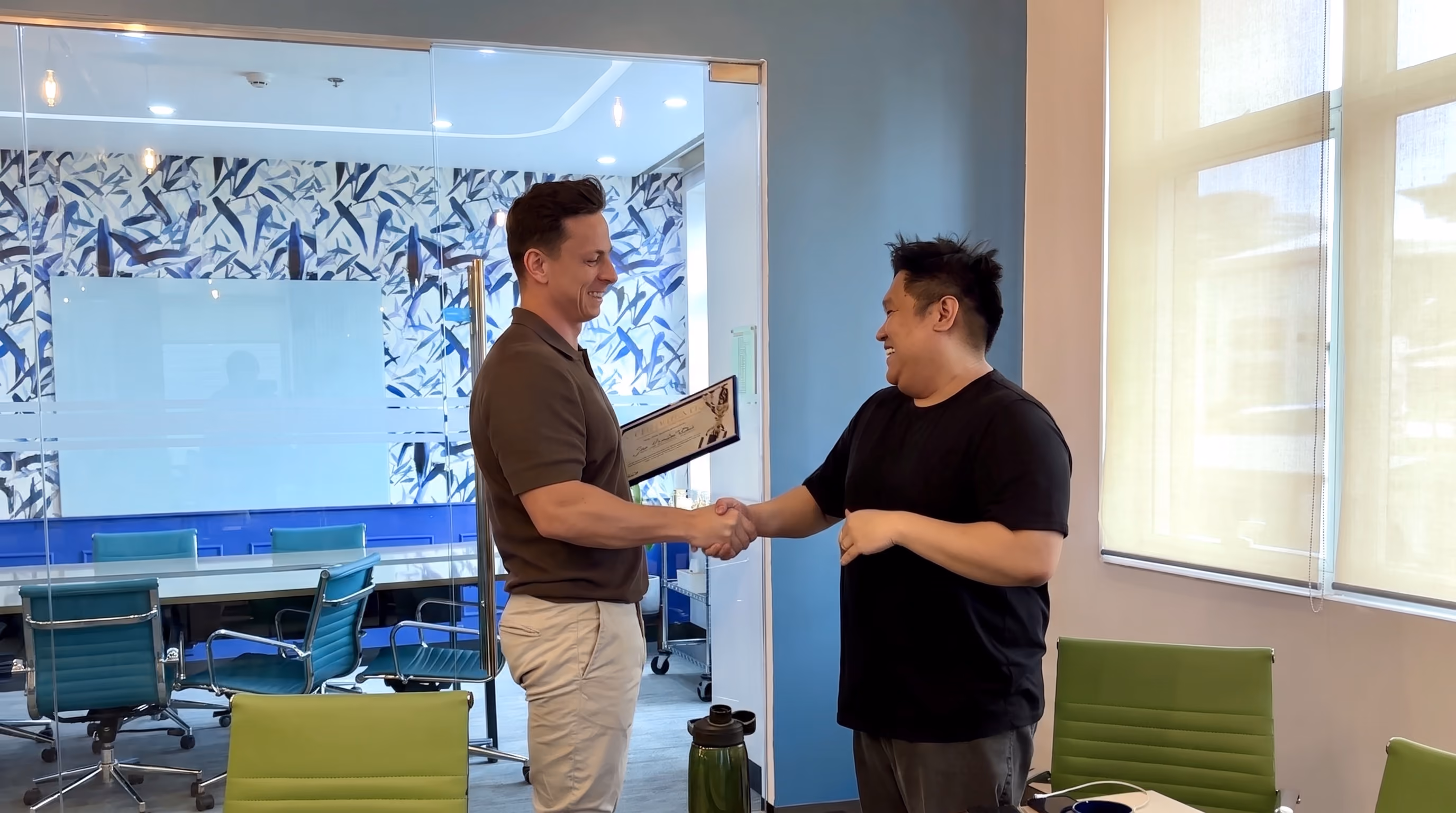The MGP team in the Manila office — Ryan Halson congratulating a team member