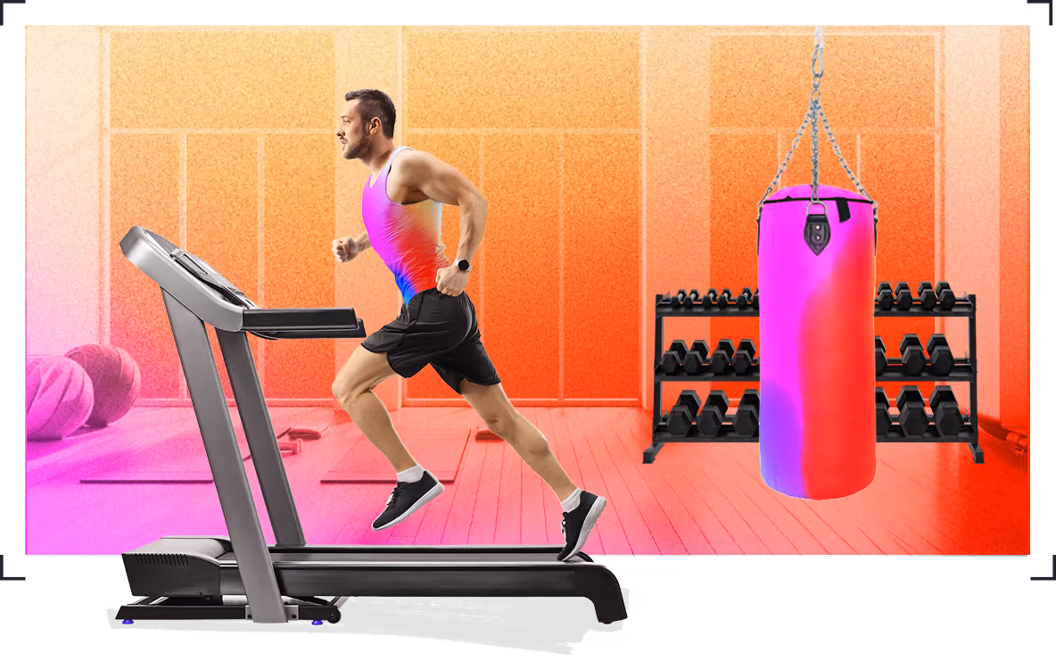 Athletic man running on treadmill in a gym with weights and a punching bag in the background.