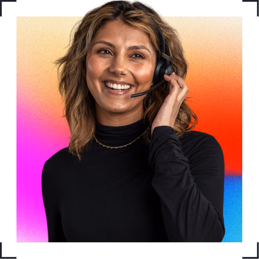 Smiling woman with headset and wavy hair in black shirt against colorful gradient background.