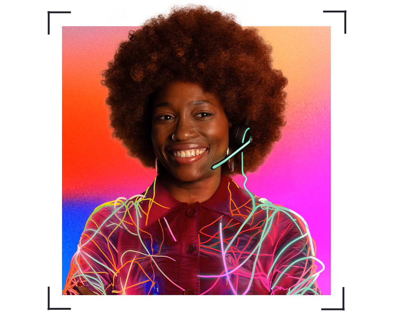 Smiling woman with an afro wearing a headset and colorful neon light lines on her red outfit.