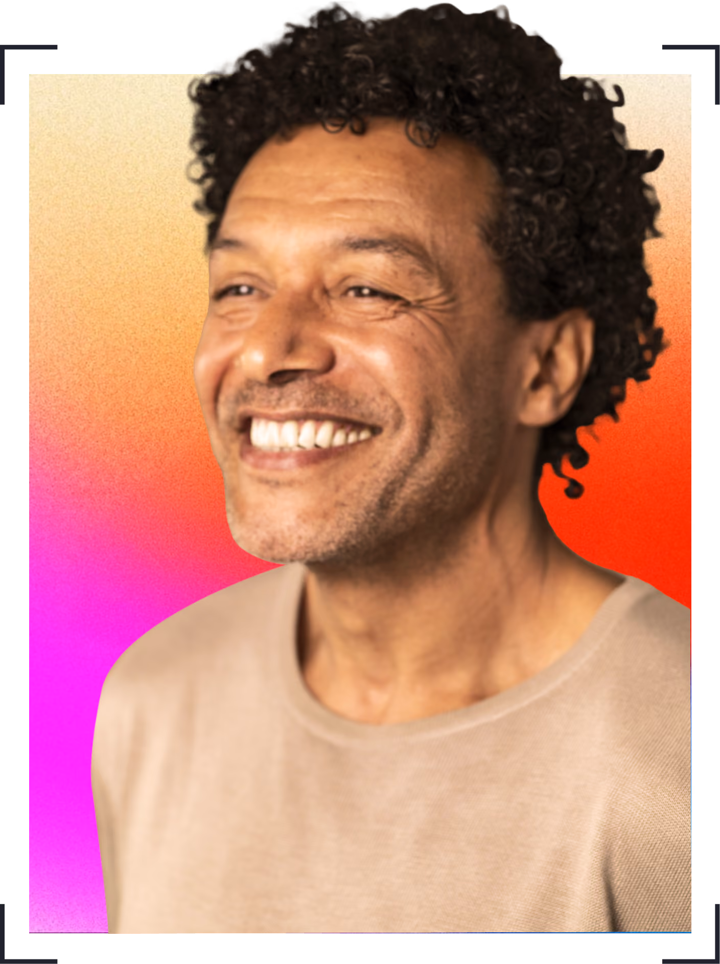 Smiling man with curly hair wearing a beige top against a vibrant gradient background.