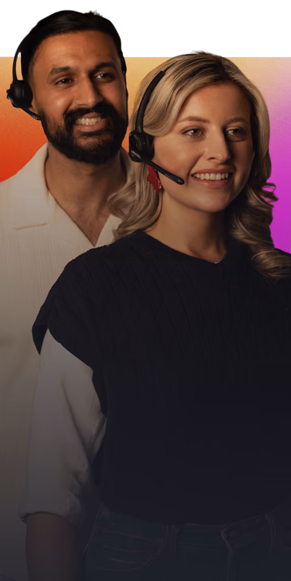 Smiling man and woman wearing headsets against a gradient orange to purple background.