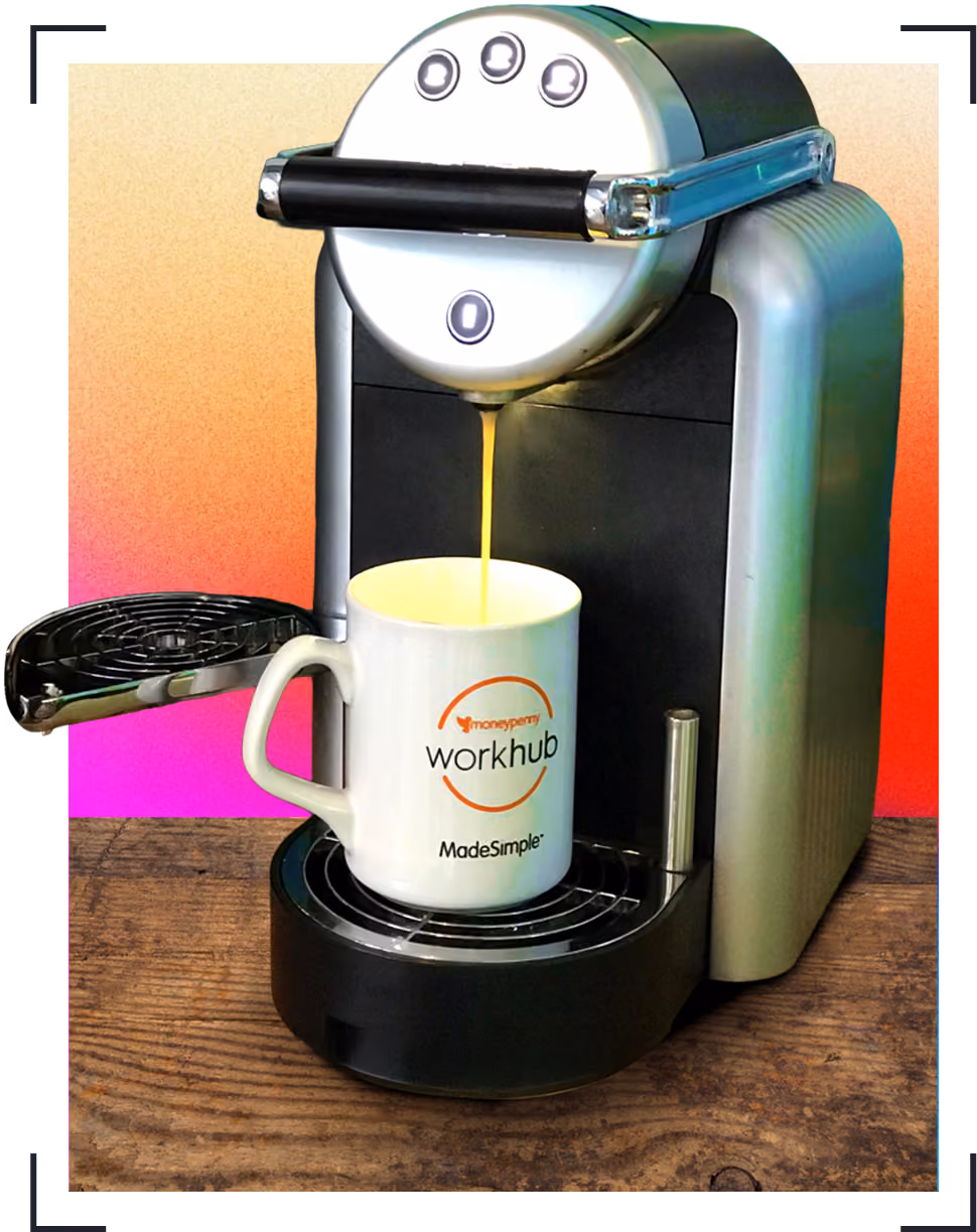 Workhub coffee machine dispensing coffee into a white mug with orange and black logo on a wooden surface.
