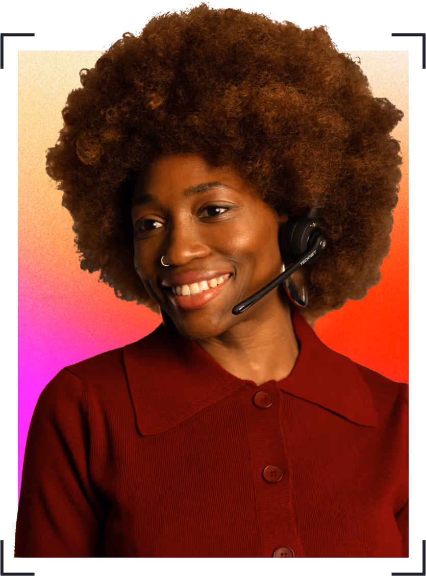 Smiling woman with wearing a dark red sweater and a headset microphone.