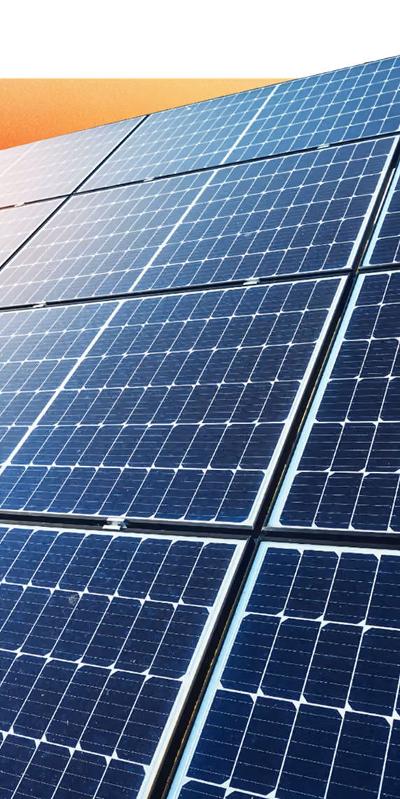 Close-up of blue solar panels angled under sunlight for renewable energy generation.