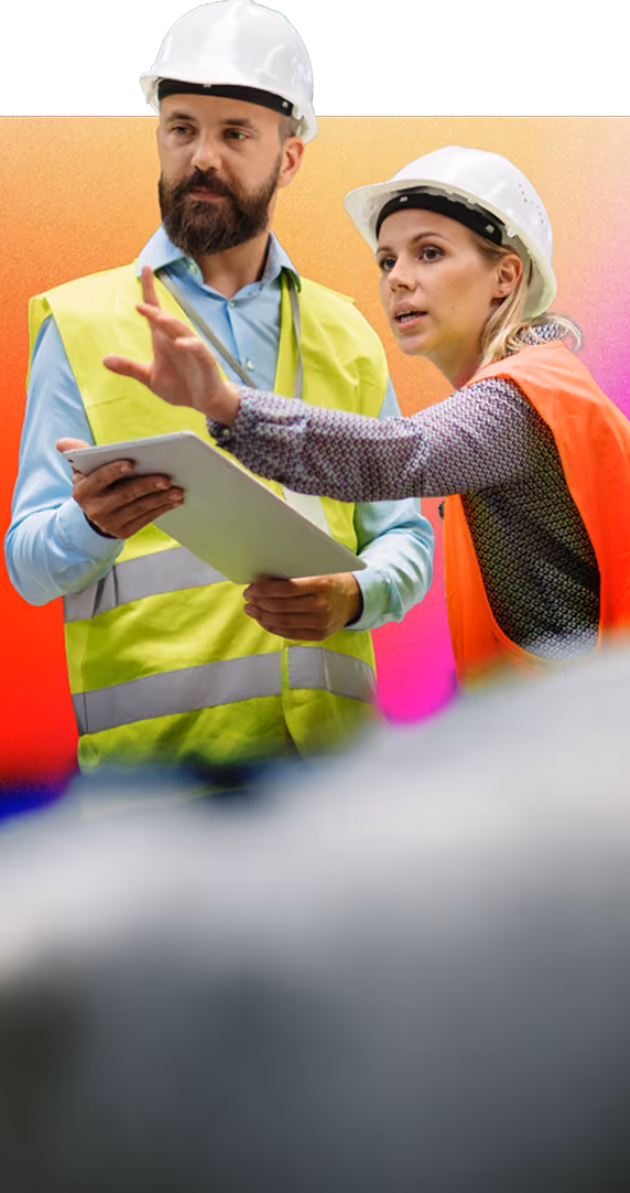Man and woman in hard hats and safety vests discuss plans using a tablet with an orange gradient background.
