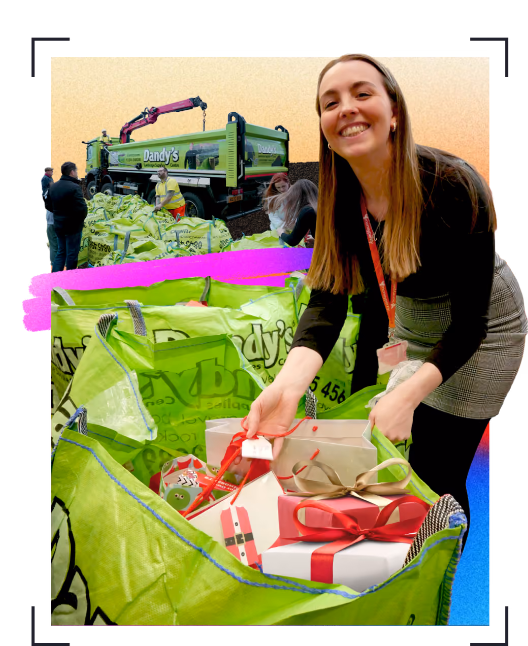 A smiling woman is placing wrapped gift boxes with bows into a large bright green bag labeled 'Dandy's'. In the background, workers unload similar green bags from a Dandy's truck with a crane attachment. This is part of Moneypenny's Give-a-Gift day.