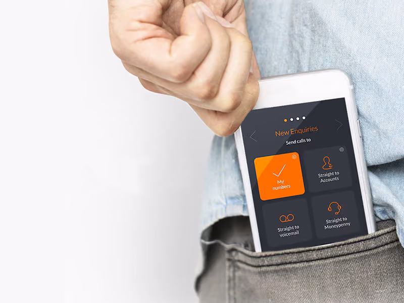 Hand pulling a smartphone from a pocket showing an app screen with call routing options for new enquiries.