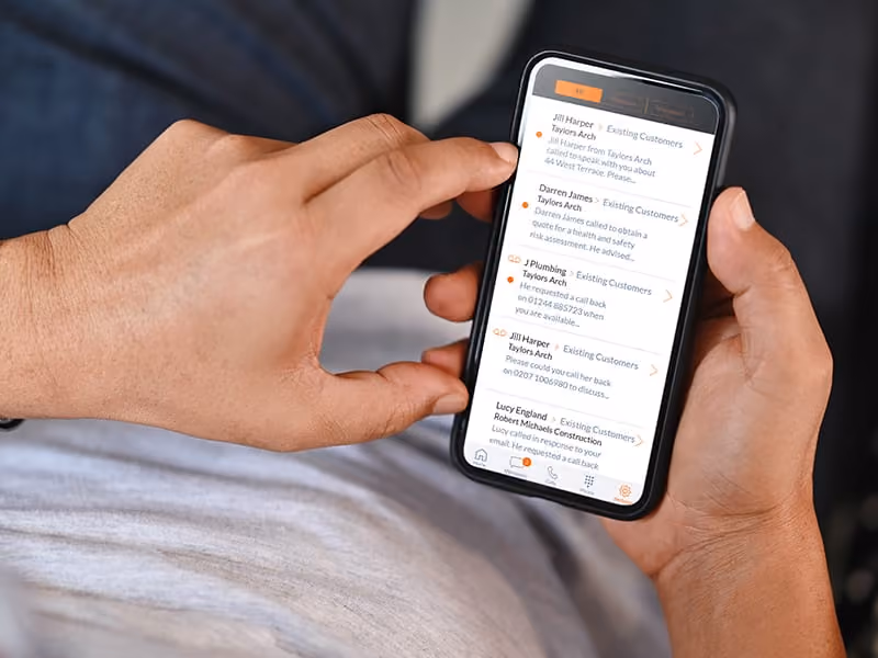 Person holding smartphone displaying a messaging app with customer call-back requests.