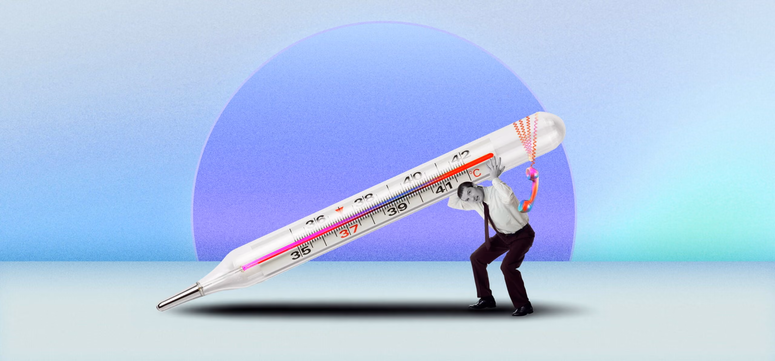 Man in business attire holding up an oversized thermometer showing high temperature.