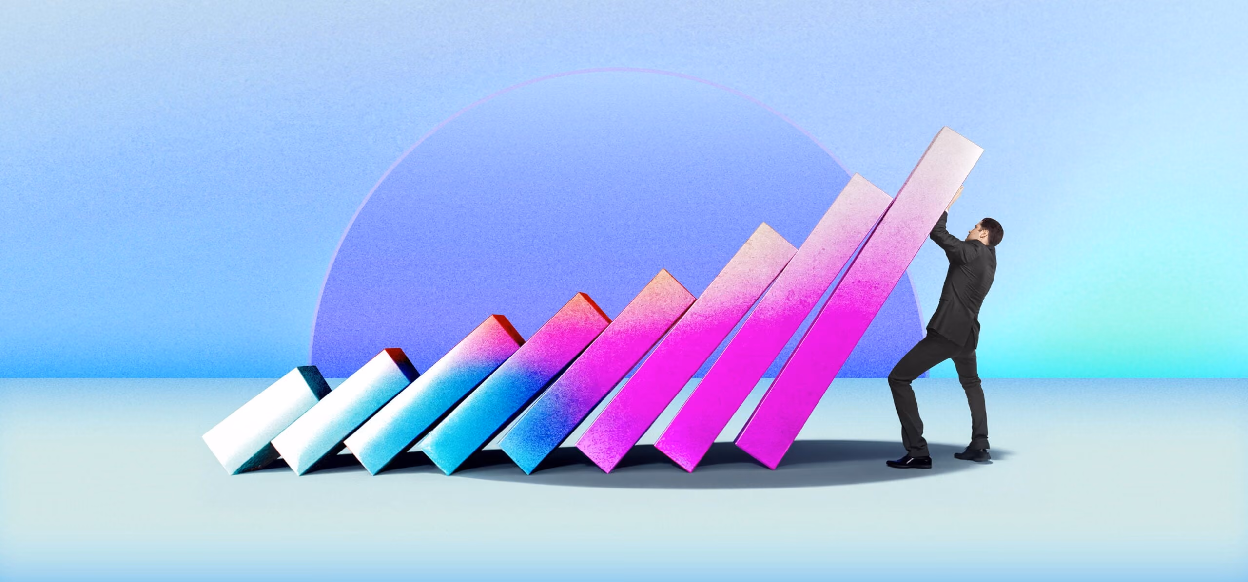Man in suit stopping a row of colorful dominoes from falling in a pastel background.
