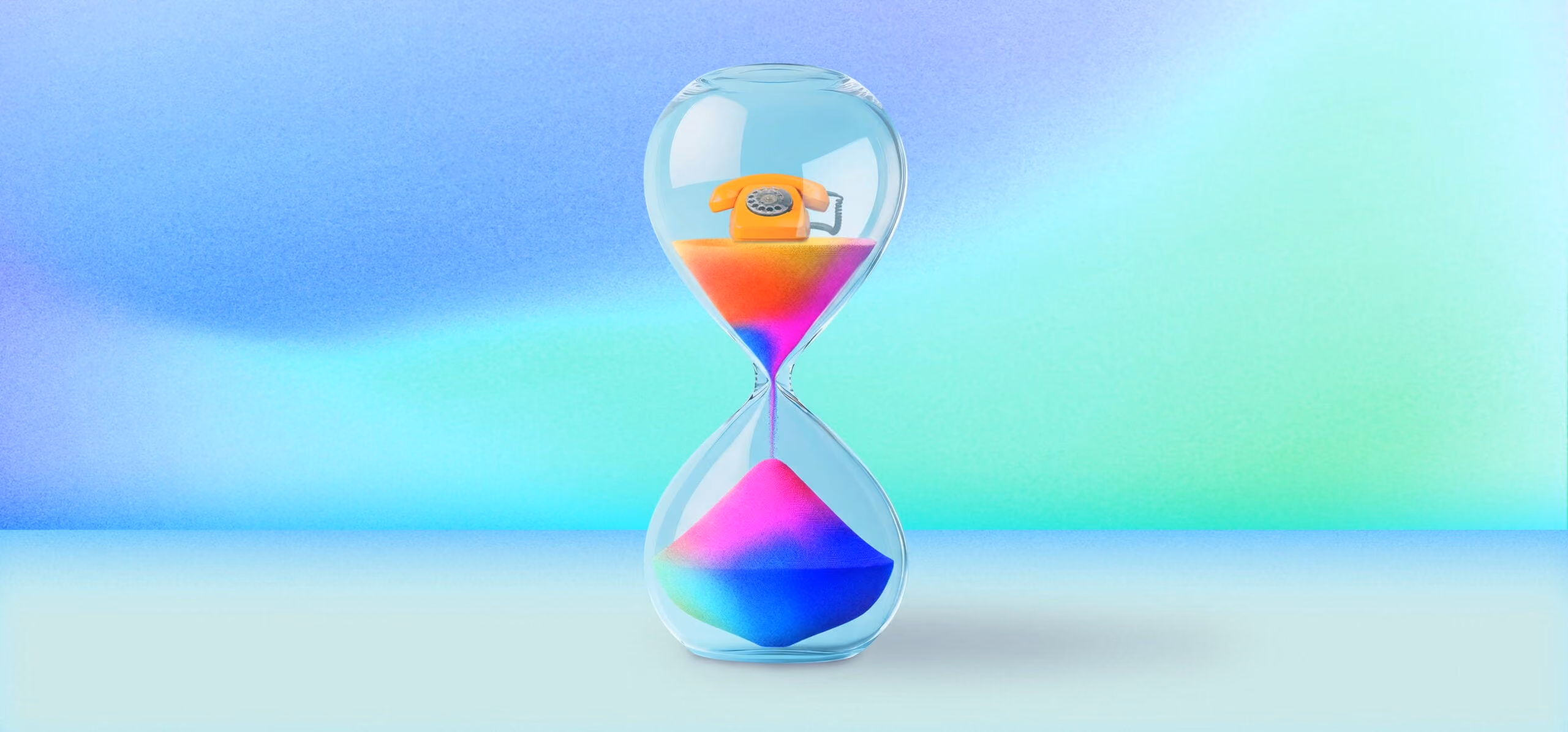 Hourglass with colorful sand and an orange rotary phone trapped in the upper bulb.