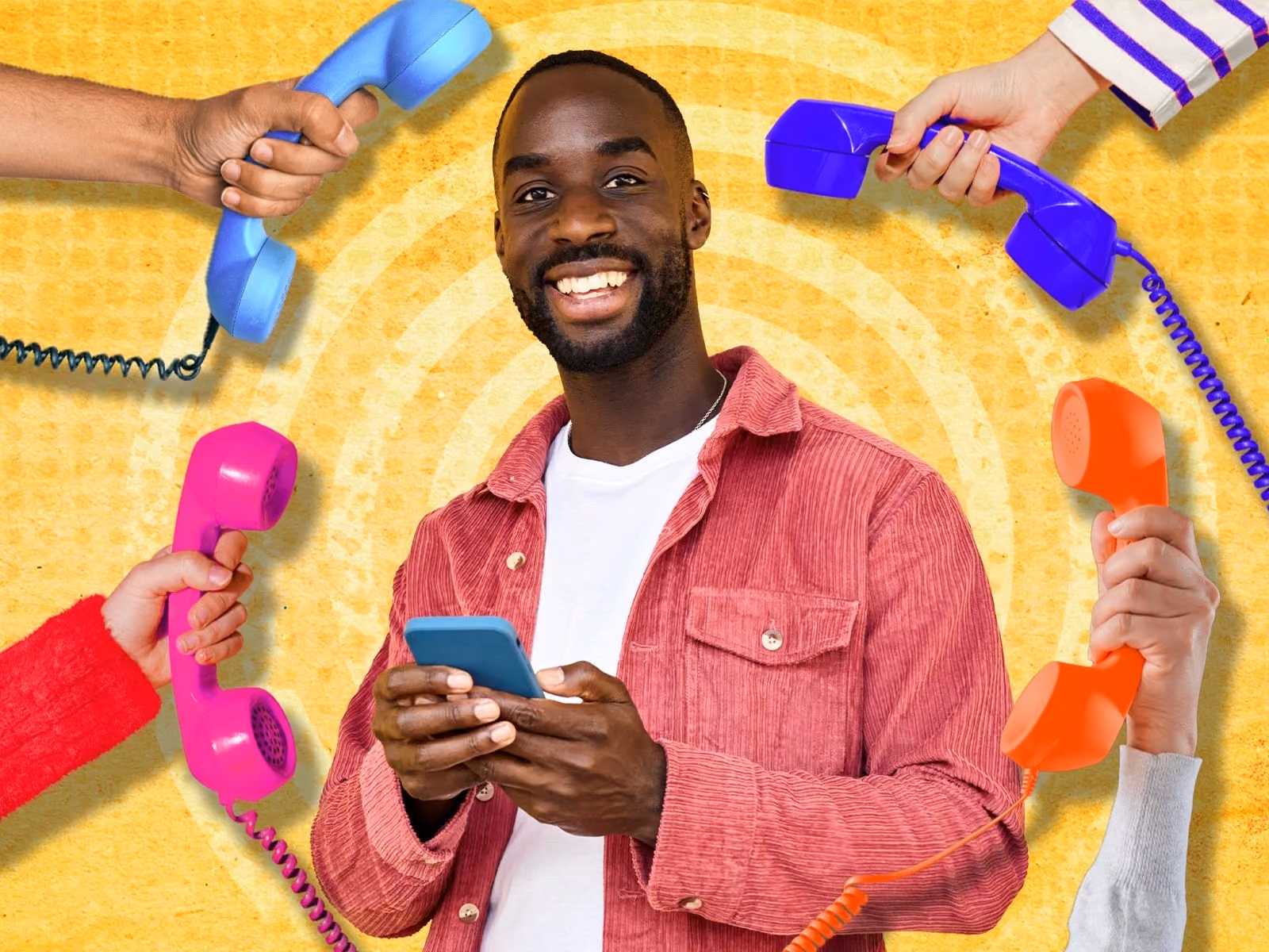 Smiling man in a red jacket holding a phone surrounded by colorful retro telephone receivers.