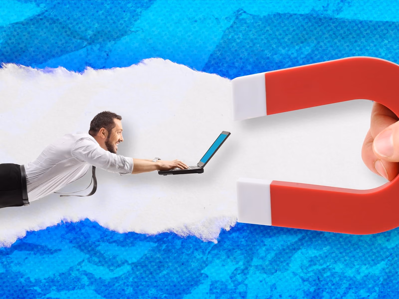Man with laptop being pulled toward a large red and white horseshoe magnet on blue torn paper background.