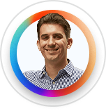 Smiling man with short brown hair wearing a checkered shirt in a circular frame with colorful border.