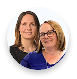 Two smiling women posing together with a white background, one wearing glasses and blue top.