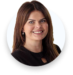 Portrait of a smiling woman with long brown hair wearing a black top and earrings.