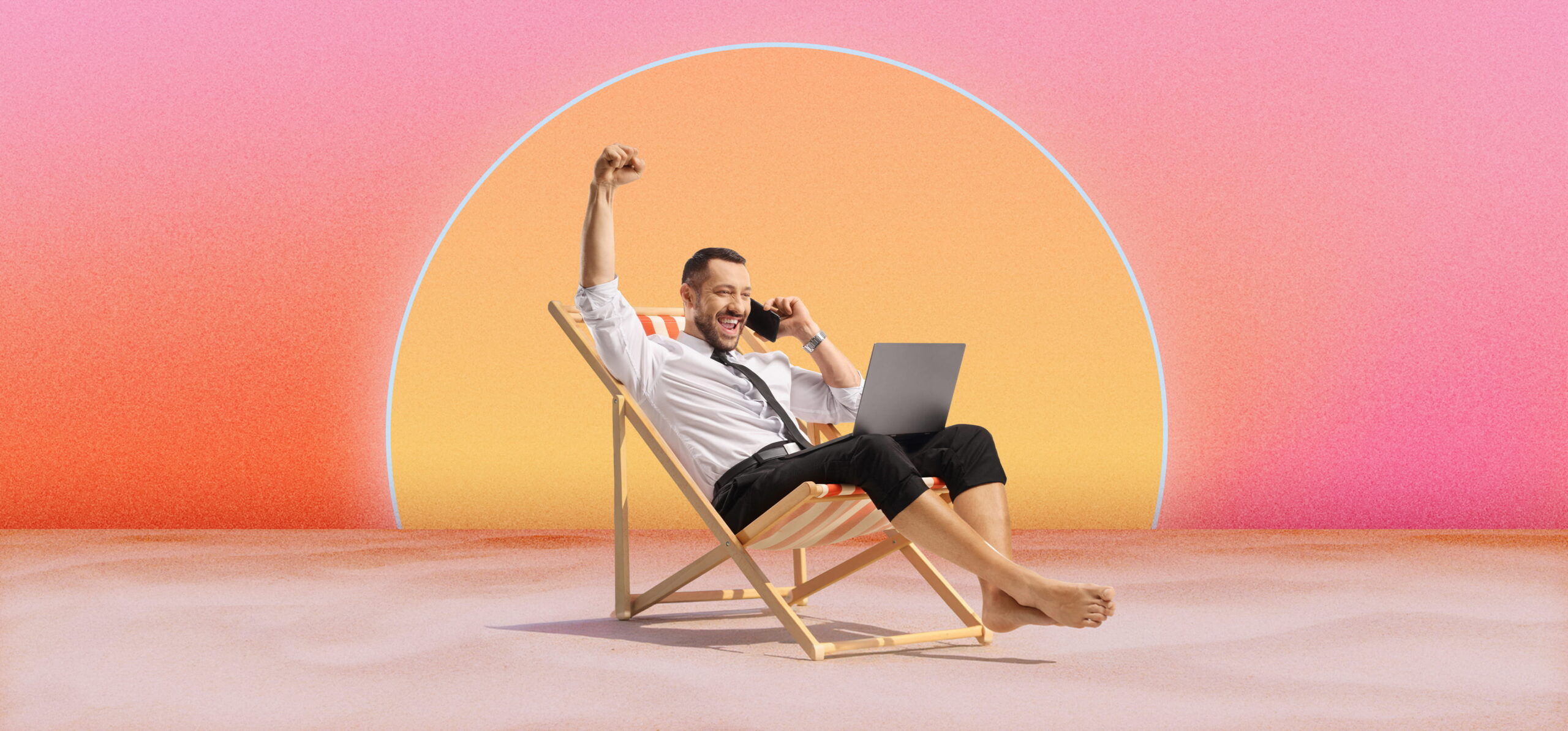 Man in business attire sitting barefoot on a striped deck chair, holding a phone to his ear and raising one fist in celebration, with a laptop on his lap and a stylised large sun with pink and orange gradient background behind him.