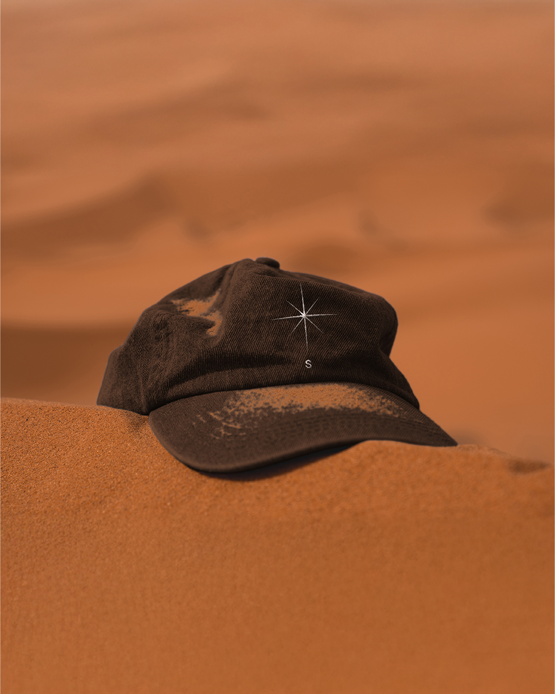 Dark Sanctuary cap on orange sand
