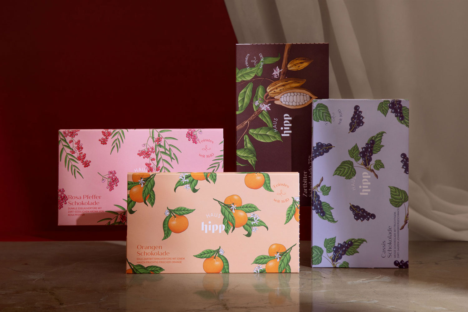 Chocolate packs with orange, berry and botanical motifs