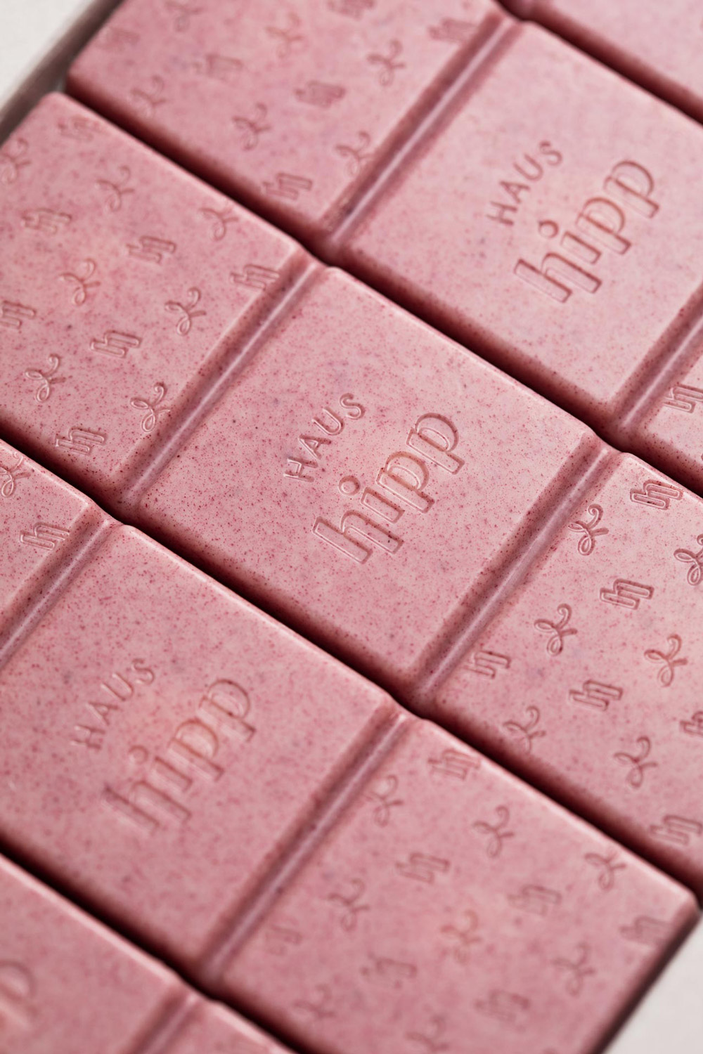 Close-up of a pink chocolate bar embossed with the Haus Hipp name