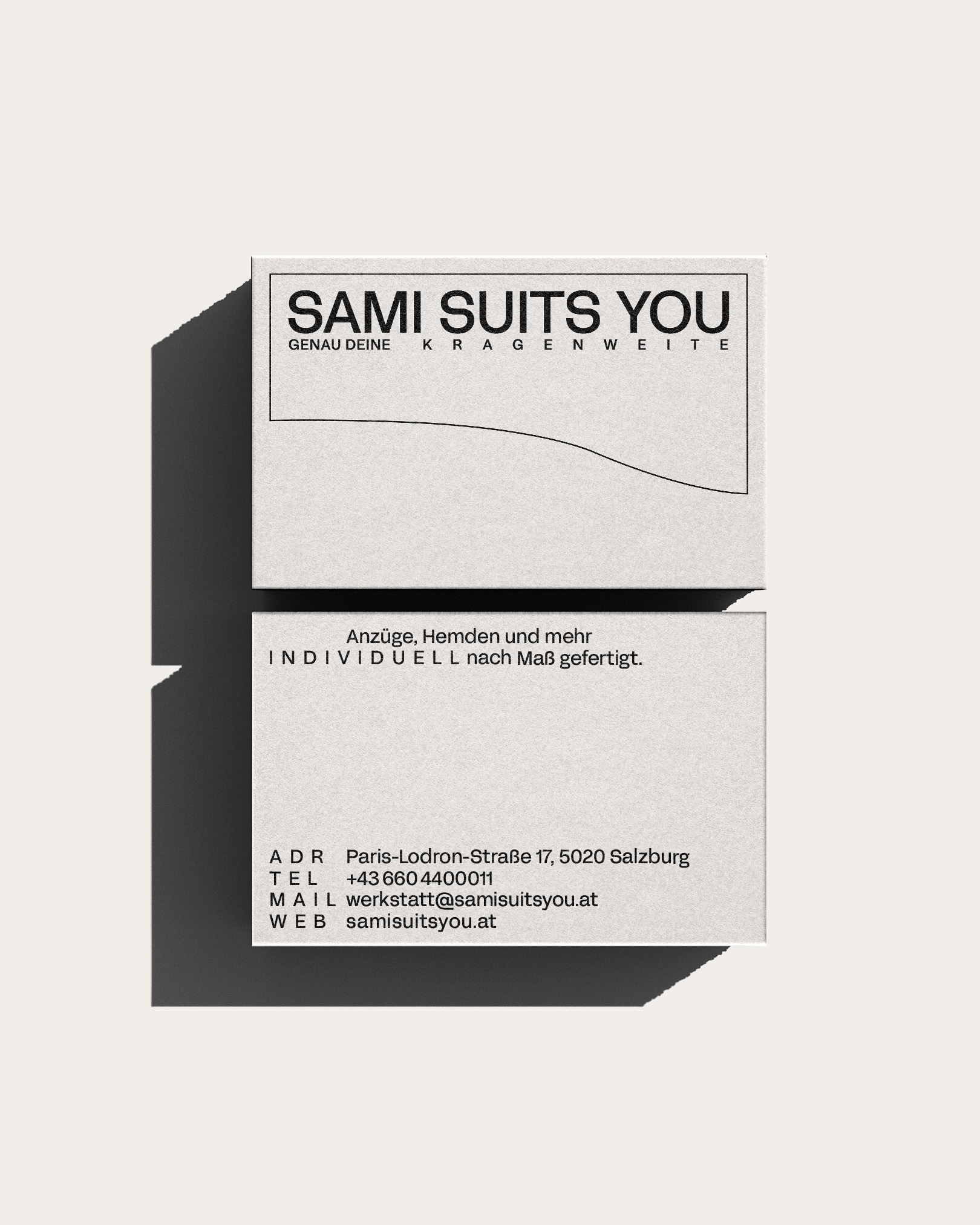 Stacked business cards with the Sami Suits You logo