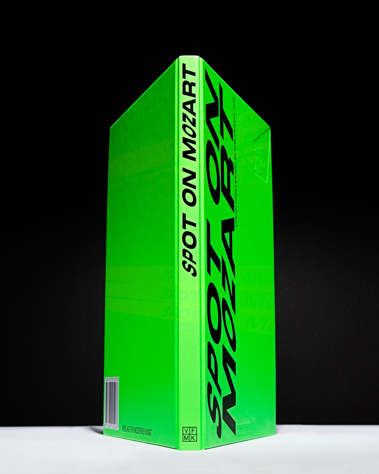 Upright Spot on Mozart book with a neon-green cover and black spine lettering
