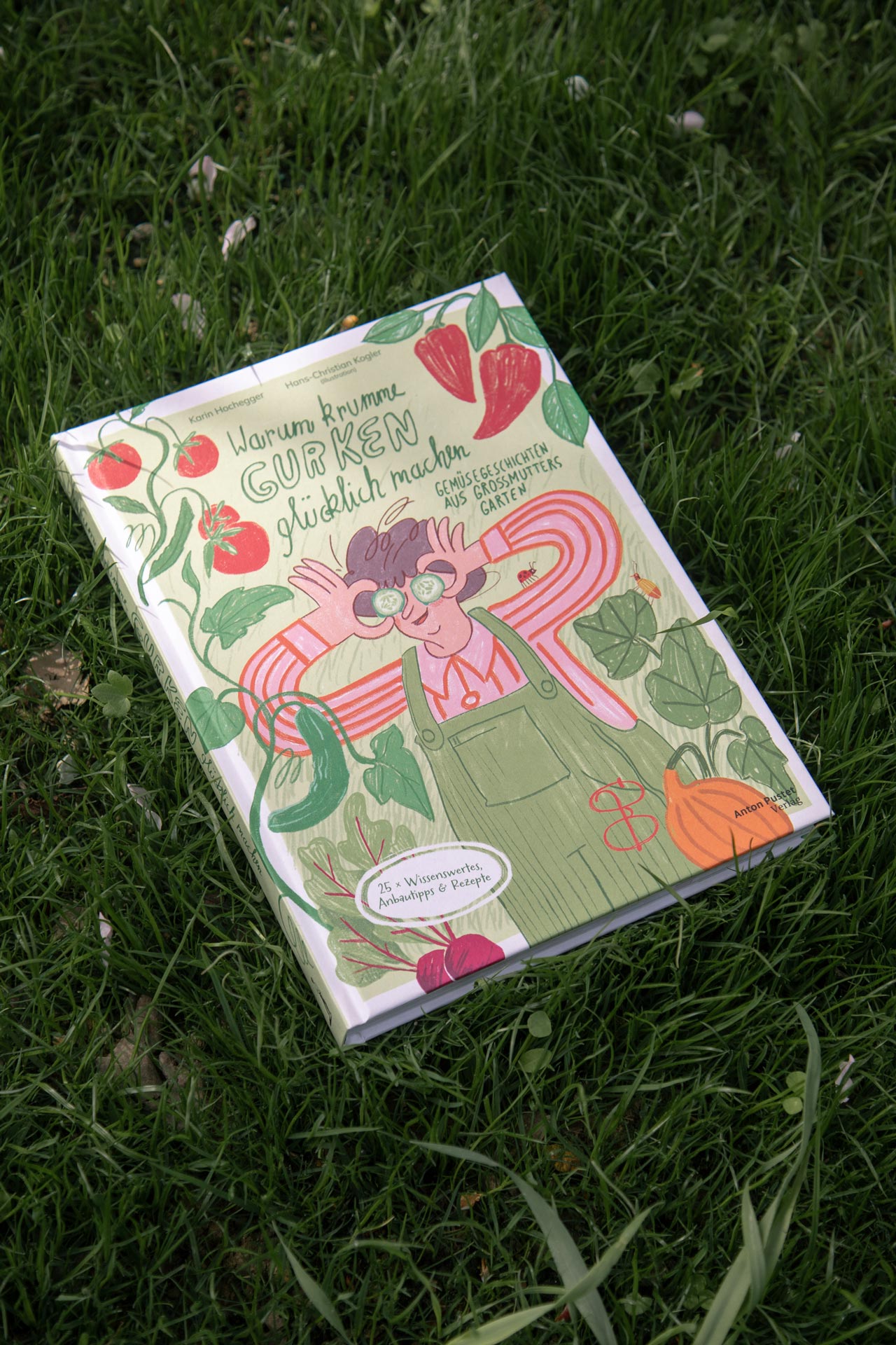Green book cover with vegetable illustrations and pink title lettering on grass