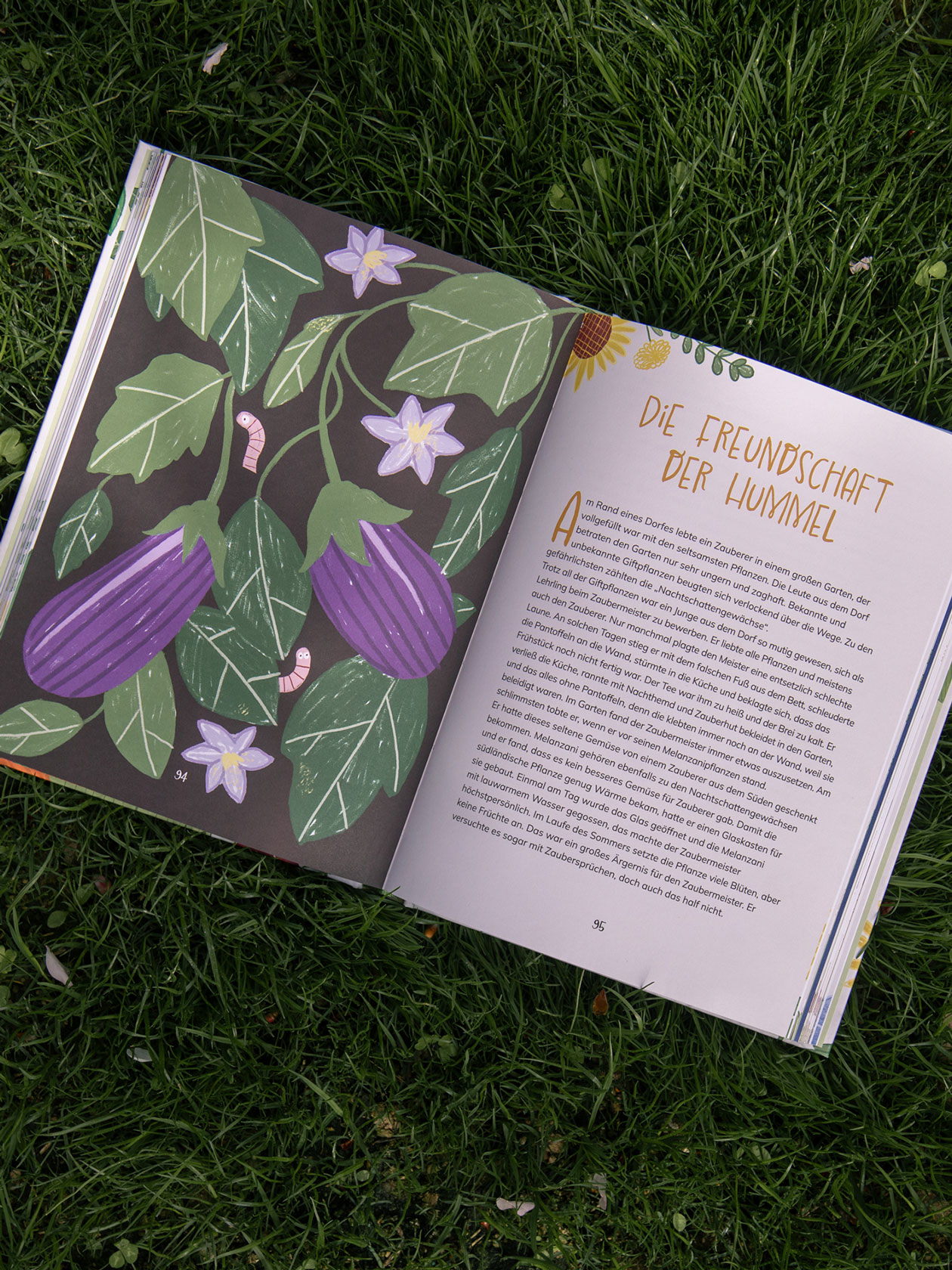 Open book spread with purple aubergine and flower illustrations