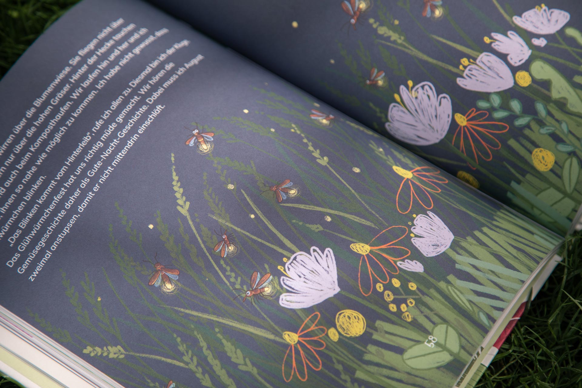Dark book spread with floral illustrations and white text