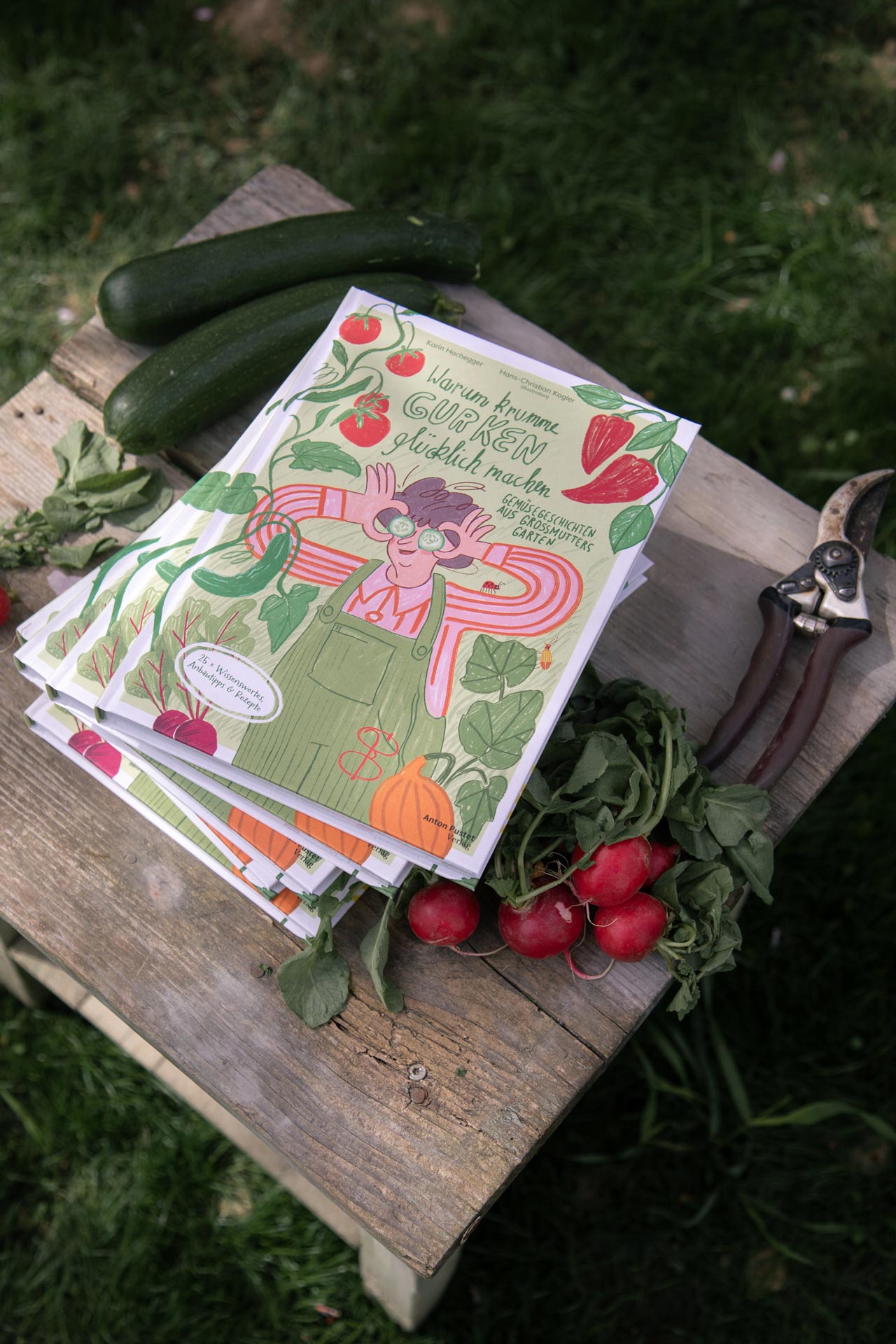 Illustrated vegetable book beside a bag and radishes on a stool