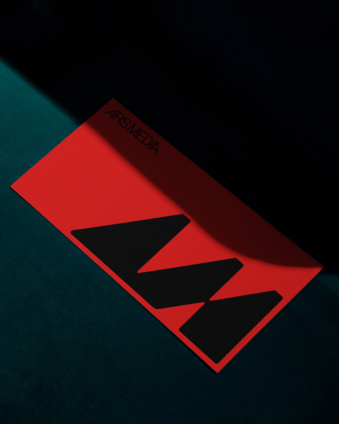 Red Ars Media card with a large black geometric symbol