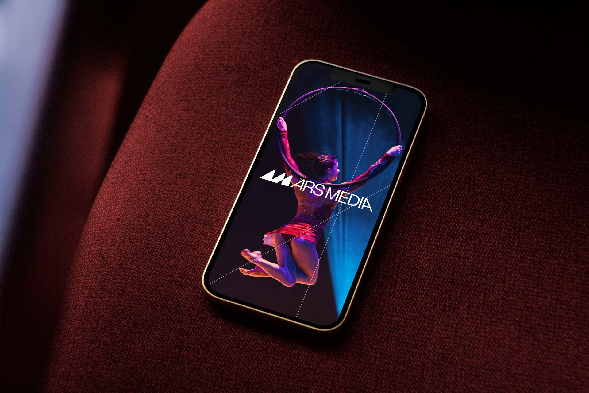 Ars Media website with a performer photograph on a smartphone