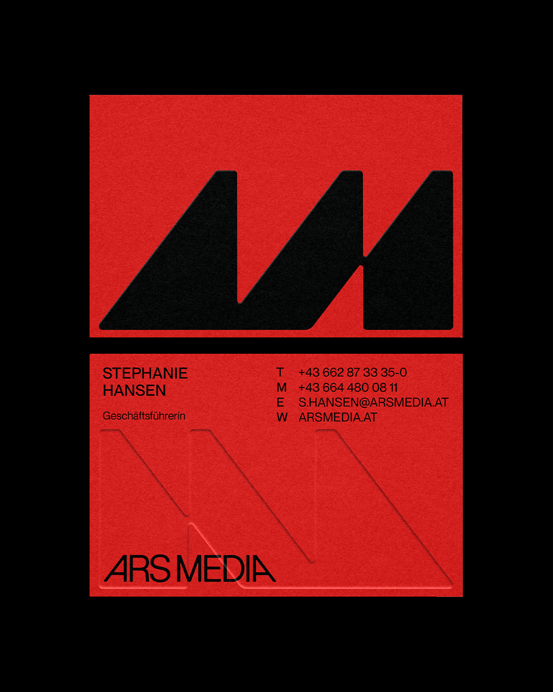 Two red Ars Media business cards on a black background