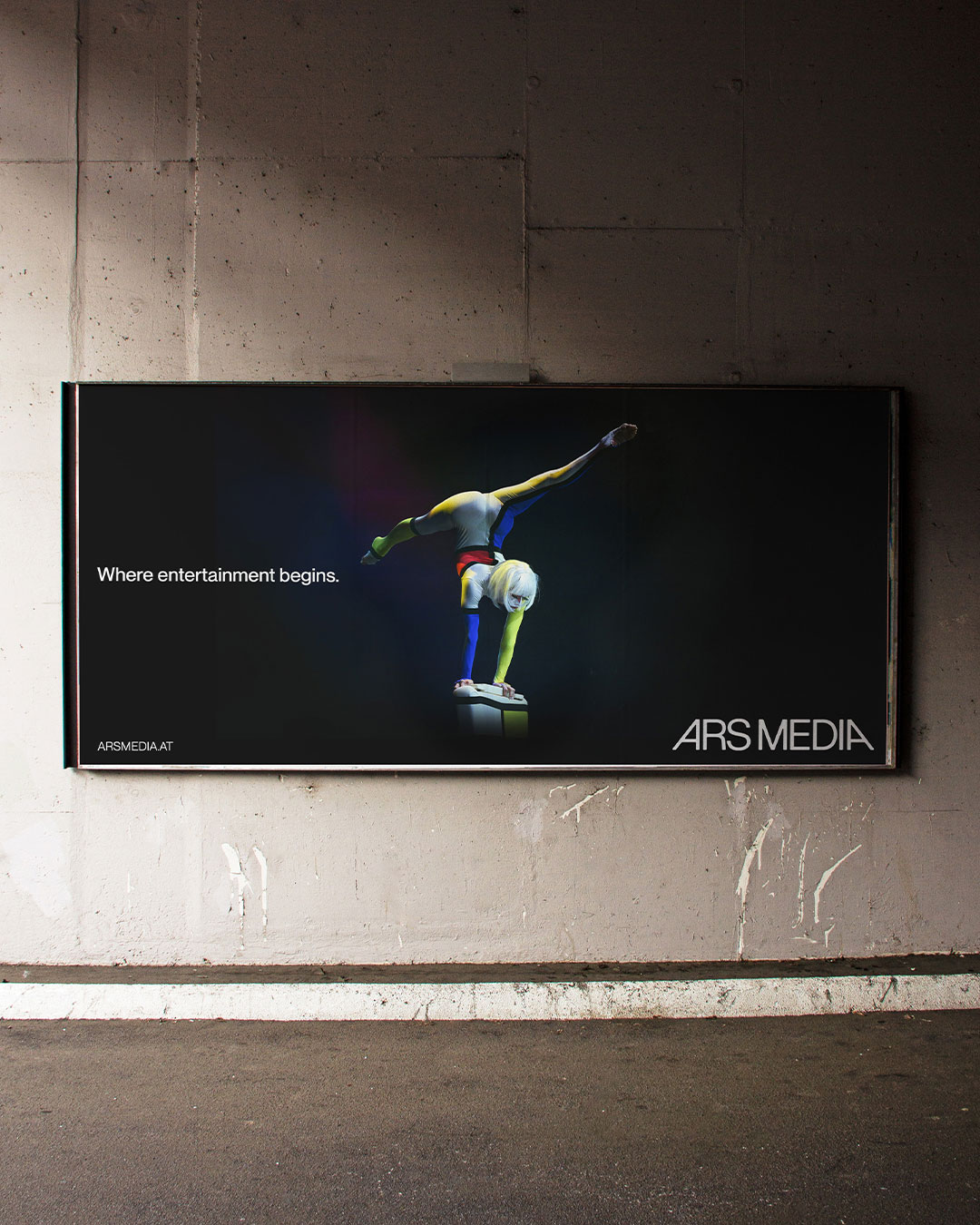 Ars Media poster with a lit stage performer on an interior wall