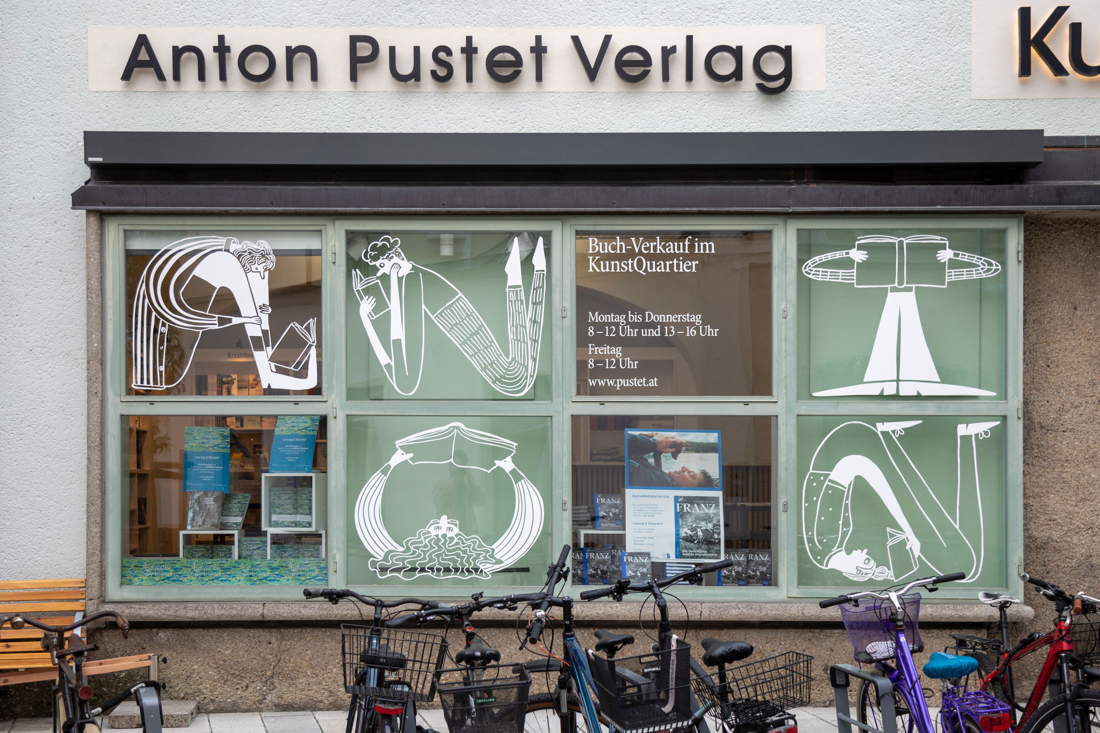 Anton Pustet Verlag facade with illustrated windows and bicycles