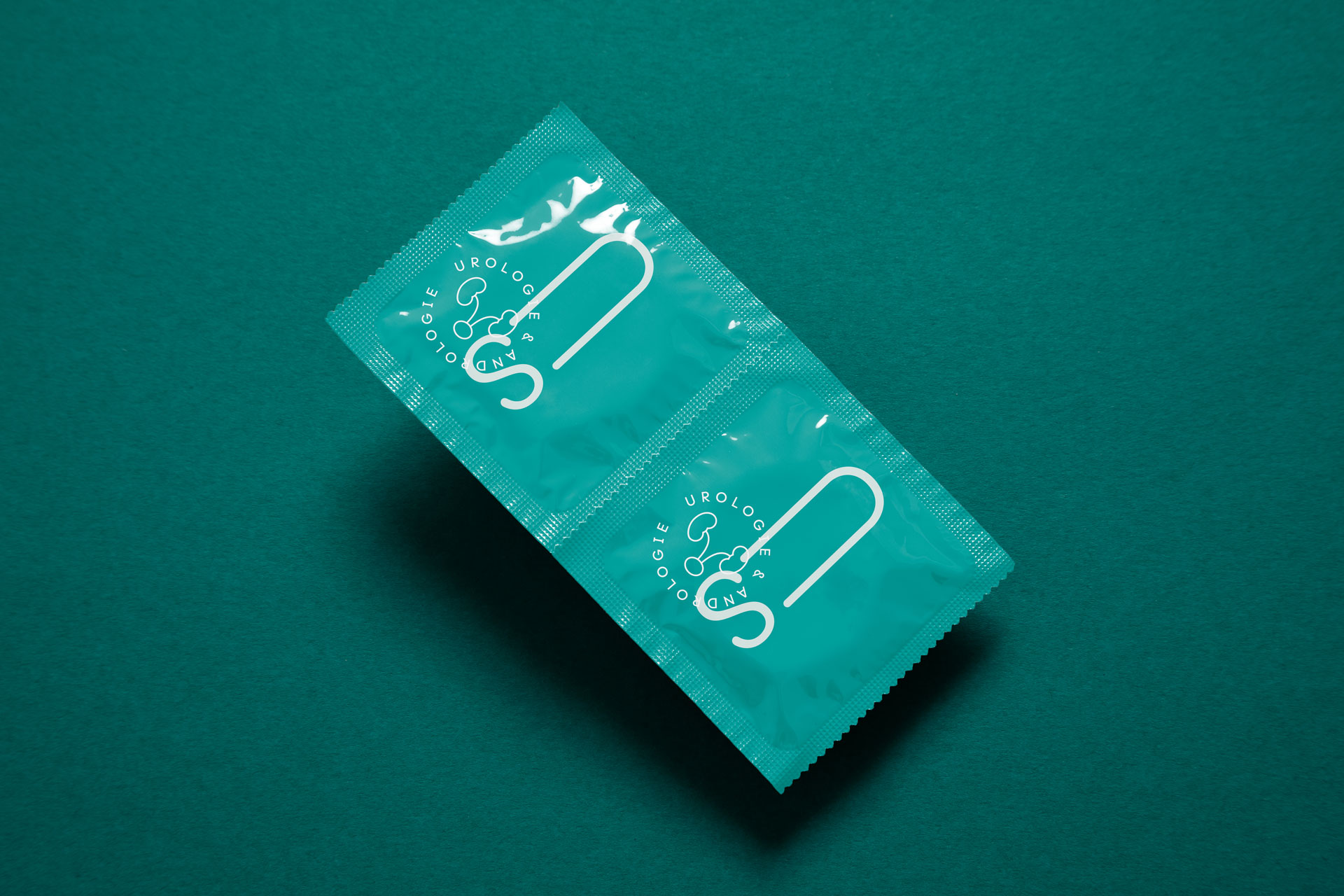 Two green printed pieces with a logo and fine illustrations