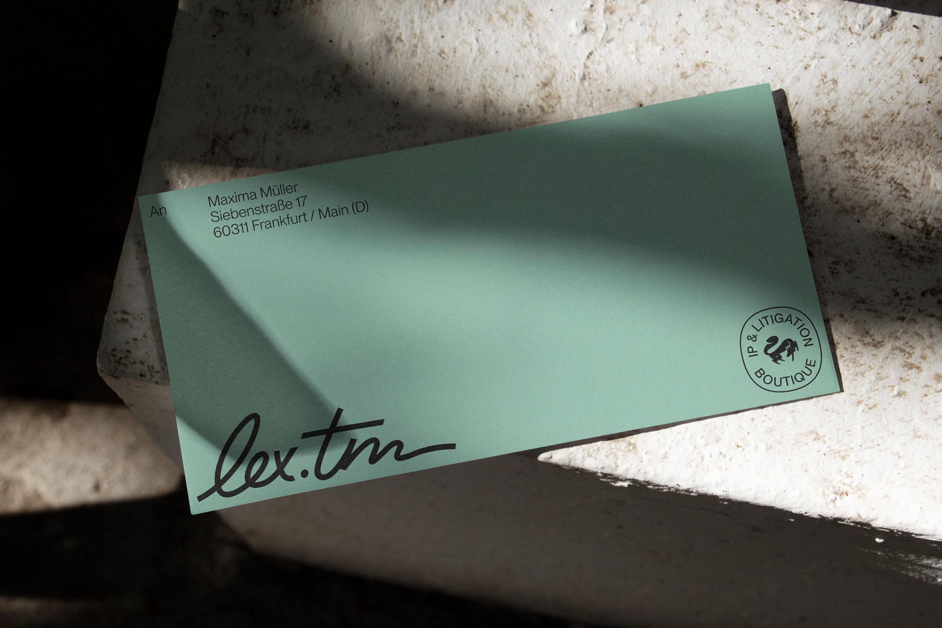 Mint-green business card with the lex.tm wordmark and circular fox seal