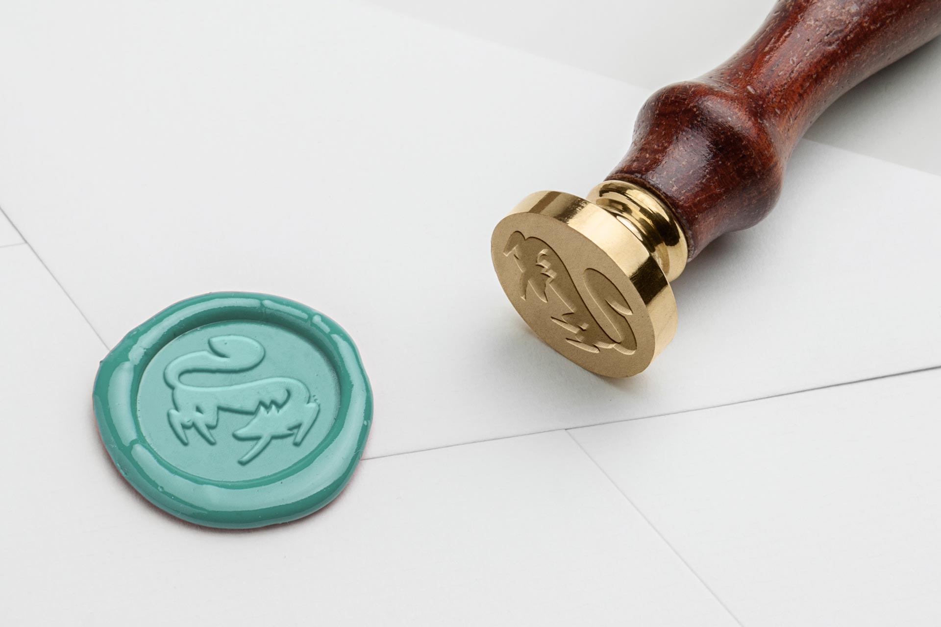 Seal stamp and mint-green wax seal with a fox motif