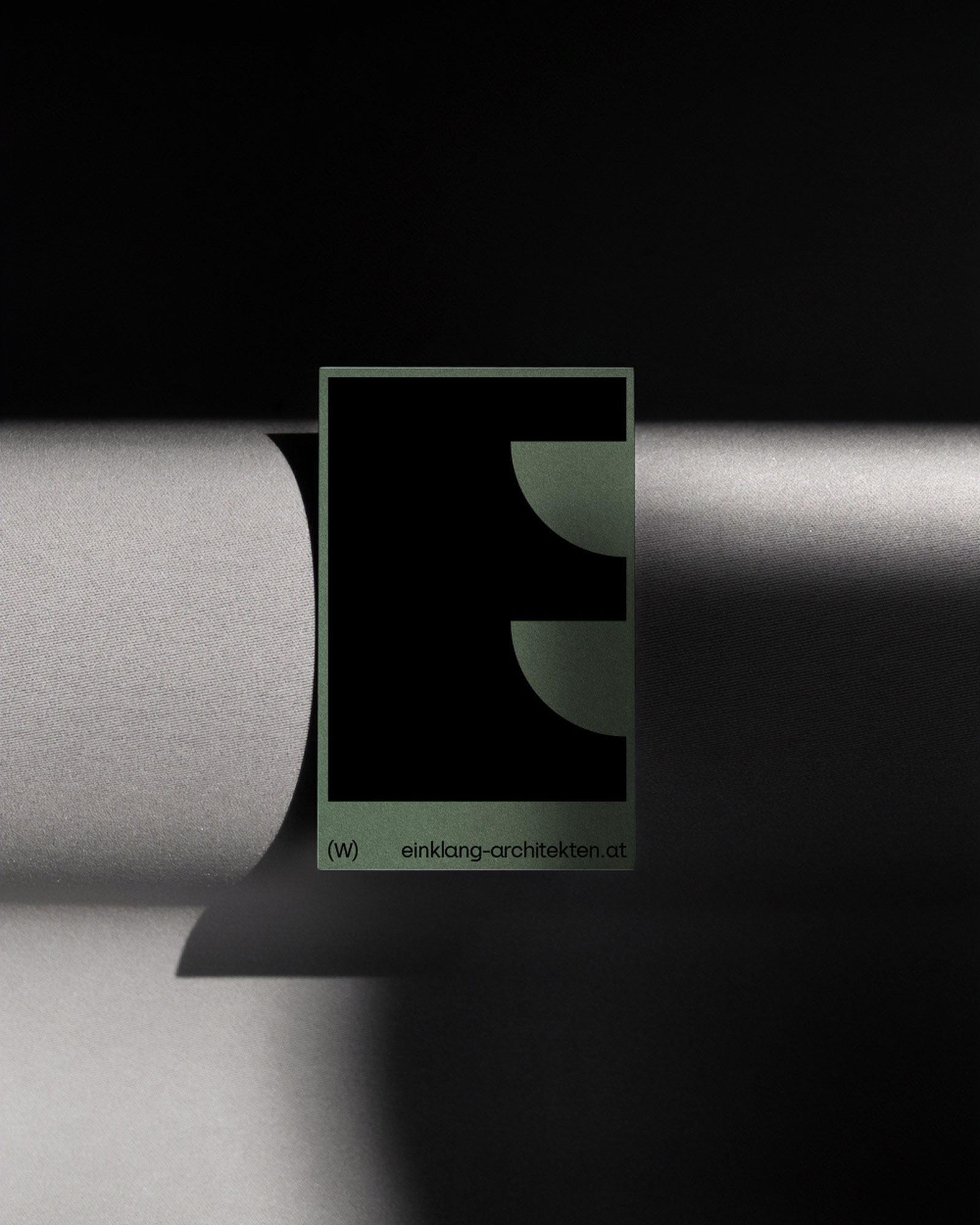 Einklang poster with a geometric symbol and green border in side lighting