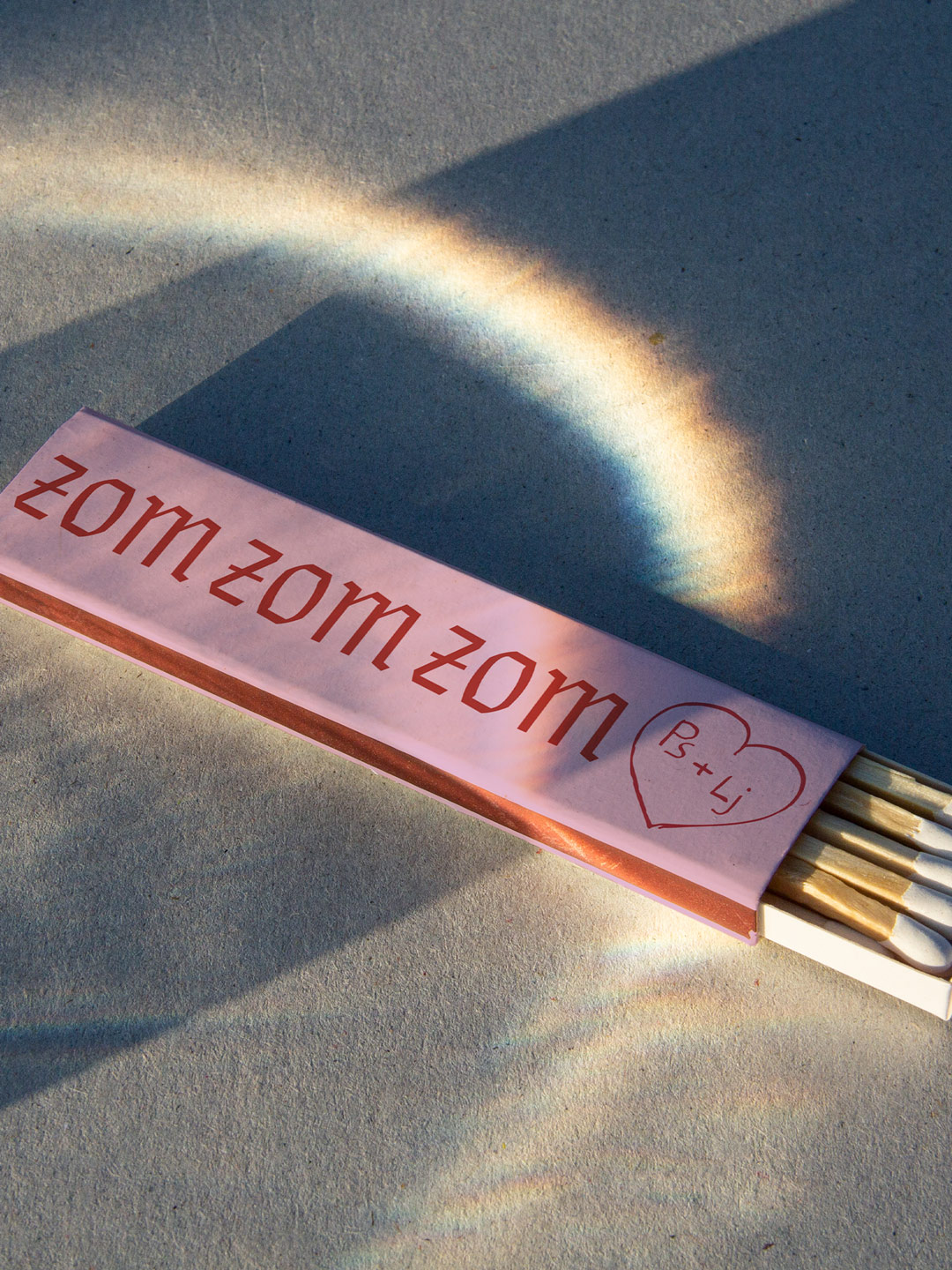 Pink Zom Zom Zom packaging in rainbow light