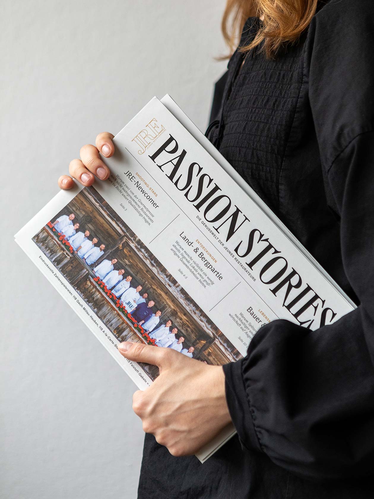 Person holding the Passion Stories magazine